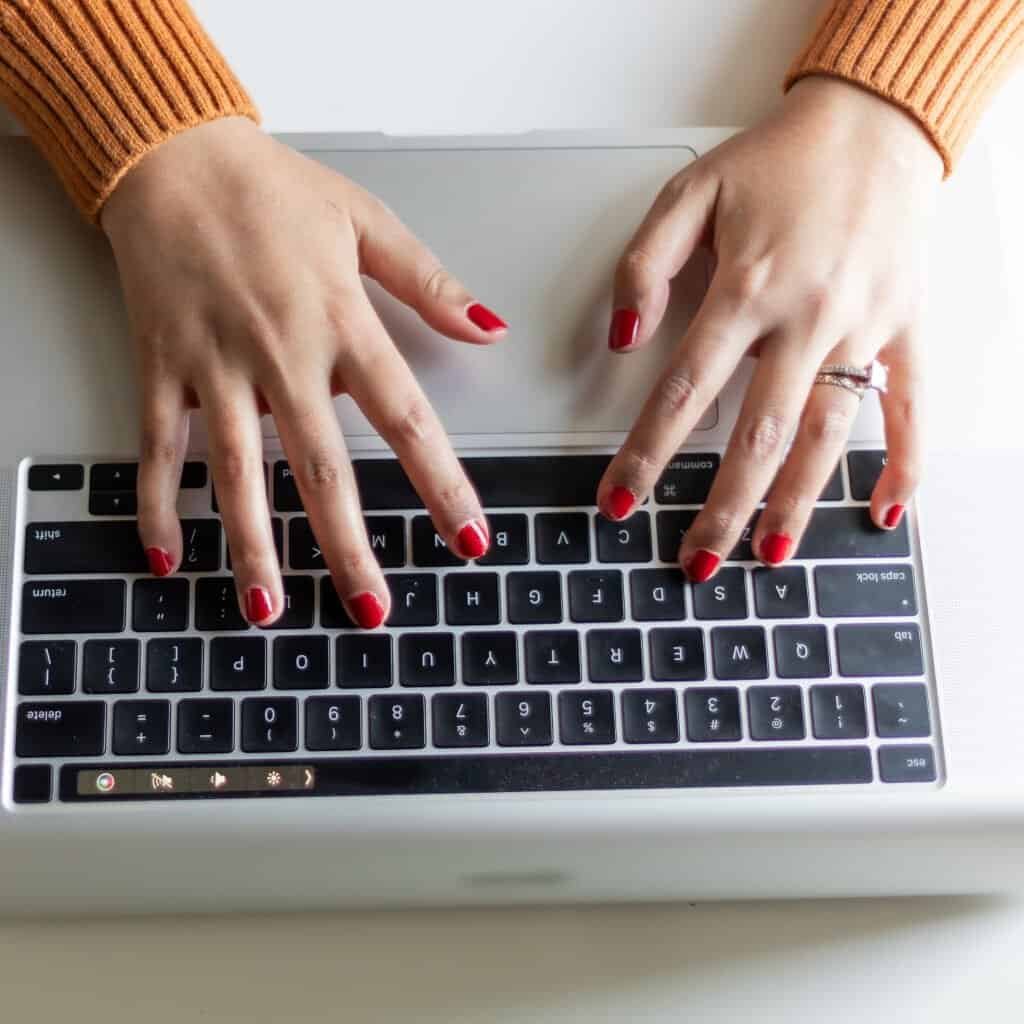 woman typing on laptop